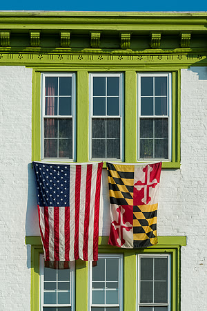 Flags between green windows