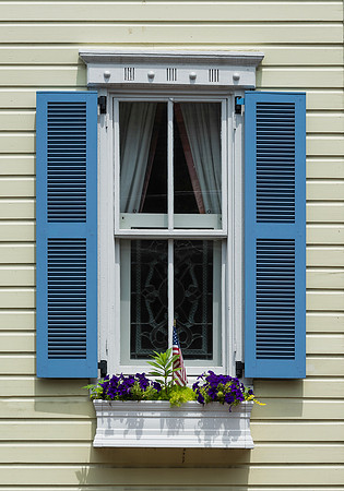 Blue shutters on yellow