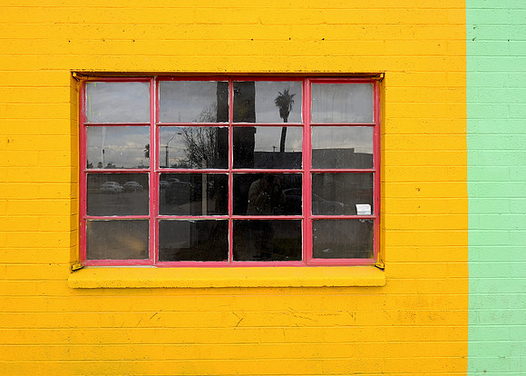 Window surrounded by yellow wall