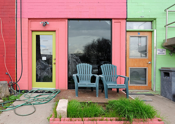 Lawn chairs in front of pink building