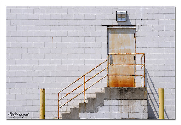 Stairway to rusty door