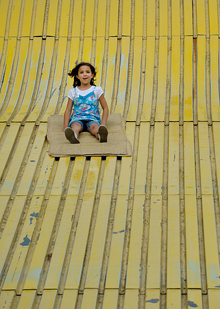 Girl on yellow slide