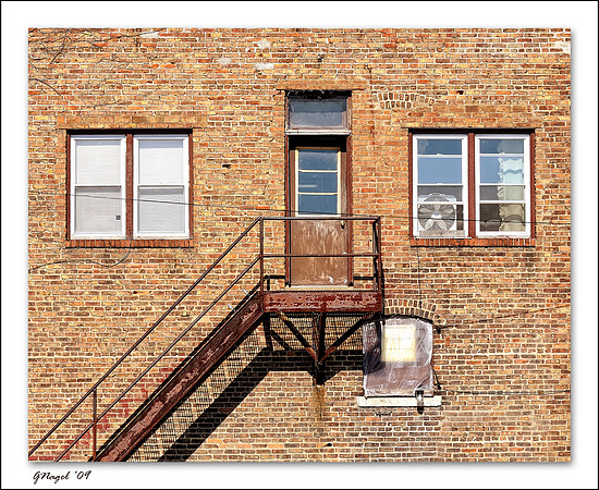 Stairway to door between two windows