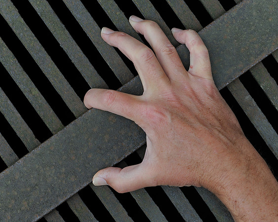 Hand on iron grate