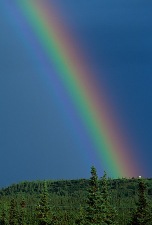 Rainbow over white cross