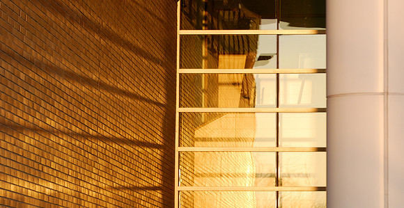 Warm light reflects onto brick wall