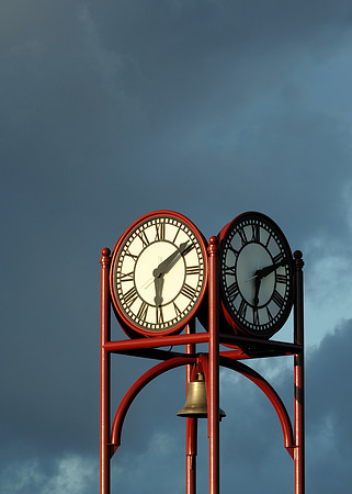 Clock against dark sky