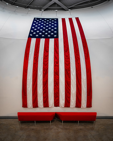 Red benches under flag
